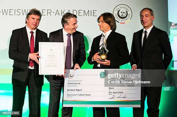 Norbert Elgert is awarded as coach of the year by DFB Vice President Ronny Zimmermann , DFB President Wolfgang Niersbach and Andreas Mueller during...