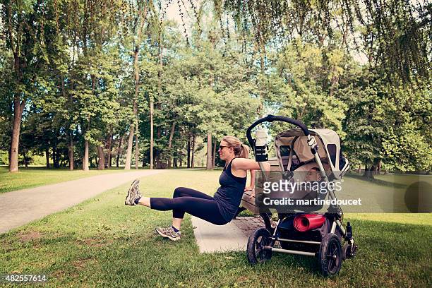 New mother doing exercises with baby sleeping in stroller.