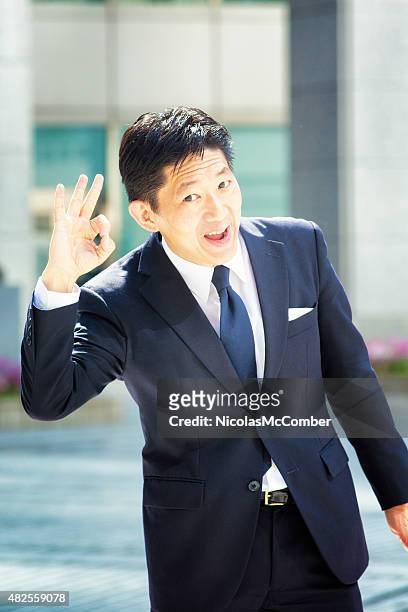 energetic japanese businessman making ok sign  office building background - super excited suit stock pictures, royalty-free photos & images