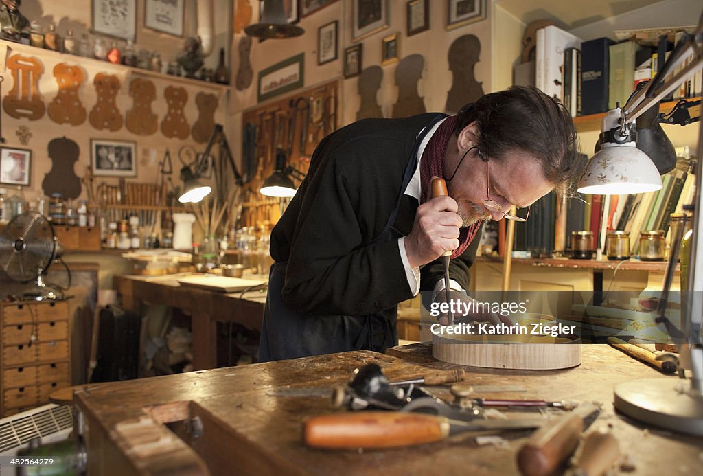 Violin maker at work in his studio