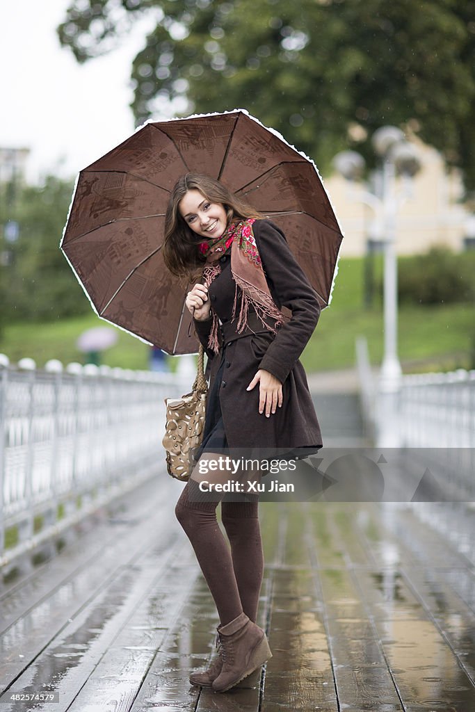 Beauty with umbrella in the rain