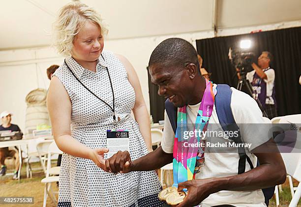 Lauren Potter visits with Special Olympics Athlete Tyson Browne during a testing at The Starkey Hearing Foundation Healthy Hearing Clinic at USC on...