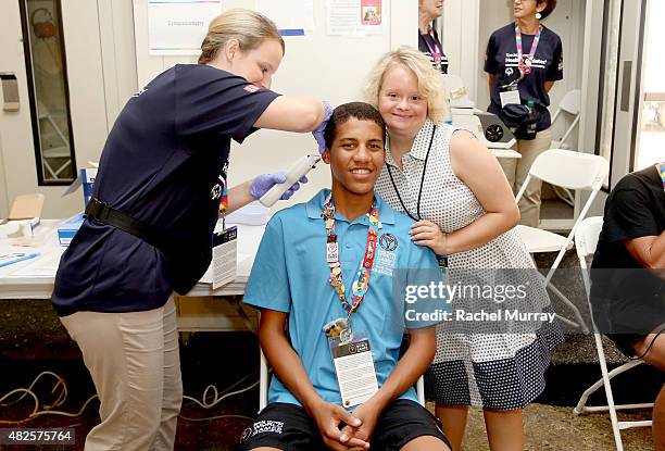 Lauren Potter visits with Special Olympics Athlete Ziyaad Manchest during a testing at The Starkey Hearing Foundation Healthy Hearing Clinic at USC...