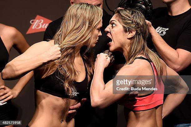 Bantamweight Champion Ronda Rousey of the United States and Bethe Correia of Brazil face off during their UFC 190 weigh-in at HSBC Arena on July 31,...