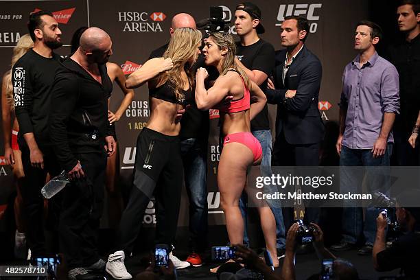 Bantamweight Champion Ronda Rousey of the United States and Bethe Correia of Brazil face off during their UFC 190 weigh-in at HSBC Arena on July 31,...