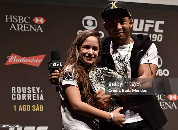 Featherweight Champion Jose Aldo of Brazil interacts with a fan during a Q&A session prior to the UFC 190 Rousey v Correia weigh-in at HSBC Arena on...