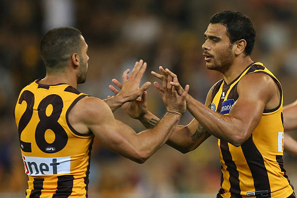 Paul Puopolo and Cyril Rioli of the Hawks celebrate a goal during the round three AFL match between the Hawthorn Hawks and the Fremantle Dockers at...