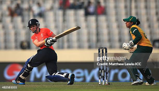 Heather Knight of England cuts the ball towards the boundary, as Trisha Chetty of South Africa looks on during the ICC World Twenty20 Bangladesh 2014...