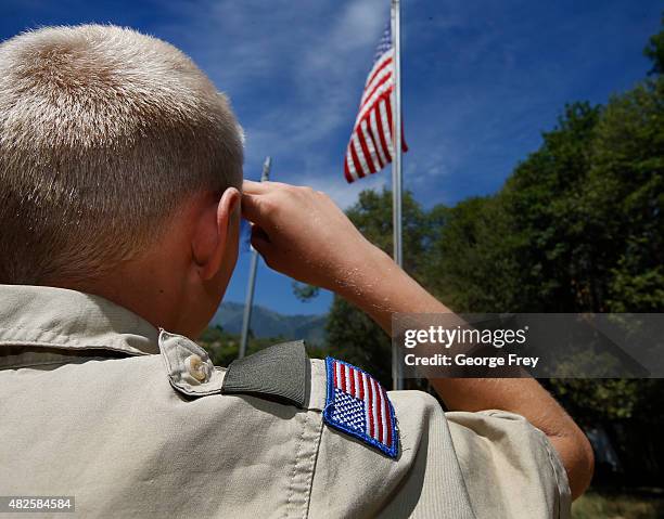 Boy Scout salutes the American flag at camp Maple Dell on July 31, 2015 outside Payson, Utah. The Mormon Church is considering pulling out of its 102...