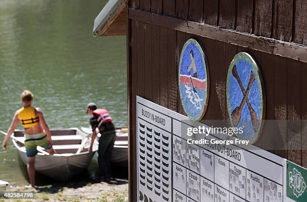 Two Boy Scout get in a row boat on a lake at camp Maple Dell on July 31, 2015 outside Payson, Utah. The Mormon Church is considering pulling out of...