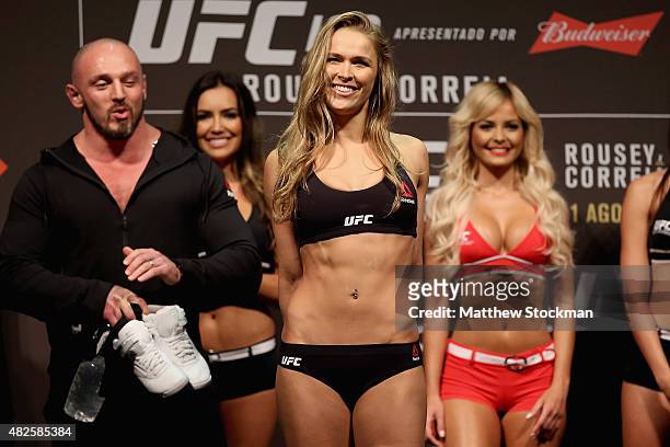 Strawweight Champion Ronda Rousey of the United States steps onto the scale during the UFC 190 Rousey v Correia weigh-in at HSBC Arena on July 31,...
