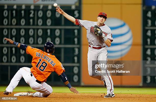 Nick Ahmed of the Arizona Diamondbacks makes a play on Luis Valbuena of the Houston Astros at second base in the sixth inning during their game at...