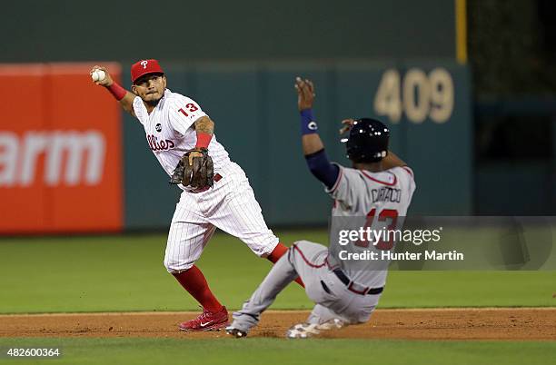 Pedro Ciriaco of the Atlanta Braves slides into second base as Freddy Galvis of the Philadelphia Phillies turns a double play in the eighth inning...