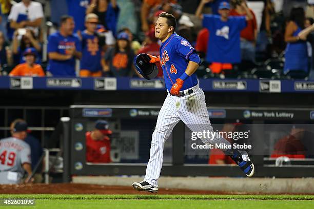 Wilmer Flores of the New York Mets celebrates after hitting a twelfth inning walk-off home run against the Washington Nationals at Citi Field on July...