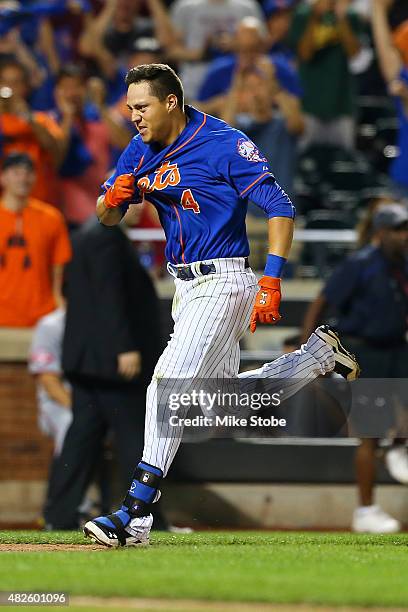 Wilmer Flores of the New York Mets celebrates after hitting a twelfth inning walk-off home run against the Washington Nationals at Citi Field on July...