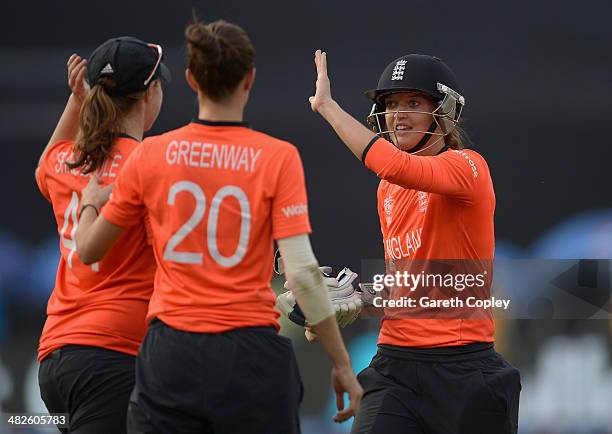 Sarah Taylor of England celebrates with Anya Shrubsole and Lydia Greenway after winning the ICC Womens World Twenty20 Bangladesh 2014 semi final...