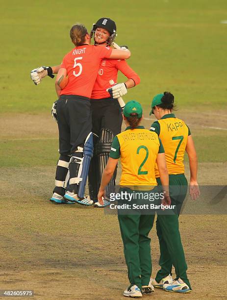 Heather Knight and Sarah Taylor of England celebrate winning the ICC Women's World Twenty20 Bangladesh 2014 2nd Semi-Final match between England...