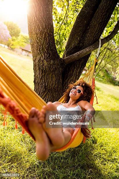 jeune femme soulevant dans un hamac - woman hammock photos et images de collection