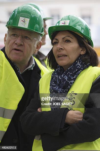 The new mayor of Paris, socialist Anne Hidalgo, wearing a protective helmet and flanked by architect Patrick Berger, visits the Halles redevelopment...
