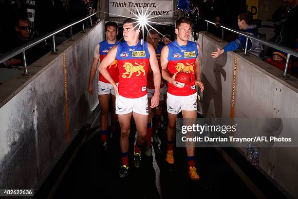 Brisbane Lions players run out after the half time break during the round 18 AFL match between the Geelong Cats and the Brisbane Lions at Simonds...