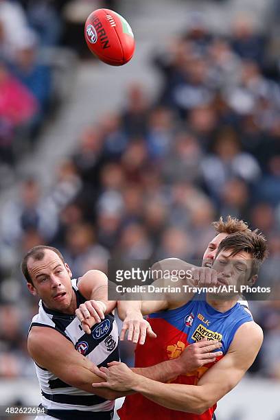Josh Walker of the Cats and Stefan Martin of the Lions compete in the ruck during the round 18 AFL match between the Geelong Cats and the Brisbane...