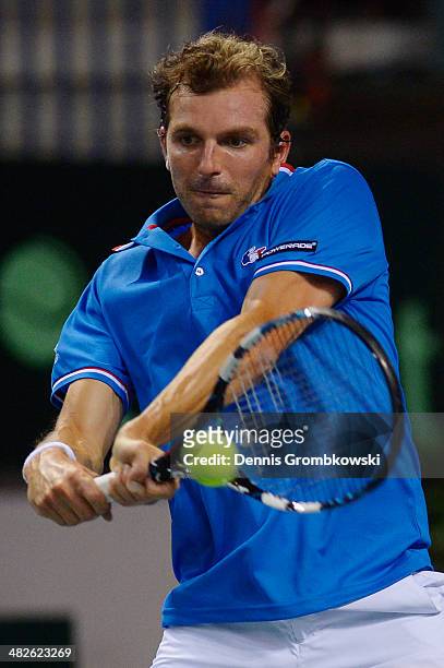 Julien Benneteau of France plays a backhand in his match against Tobias Kamke of Germany during day 1 of the Davis Cup Quarter Final match between...