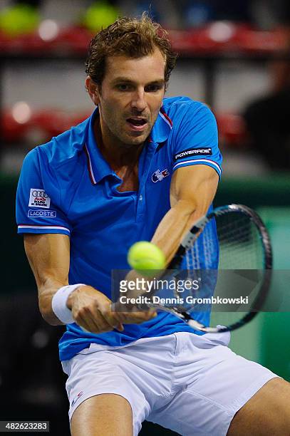 Julien Benneteau of France plays a backhand in his match against Tobias Kamke of Germany during day 1 of the Davis Cup Quarter Final match between...