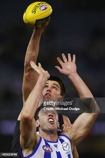 Matthew Kreuzer of the Blues competes for the ball over Todd Goldstein of the Kangaroos during the round 18 AFL match between the Carlton Blues and...