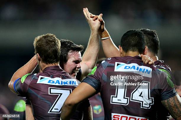 Jamie Lyon of Manly celebrates a try with team mates during the round 21 NRL match between the Manly Sea Eagles and the Brisbane Broncos at Central...