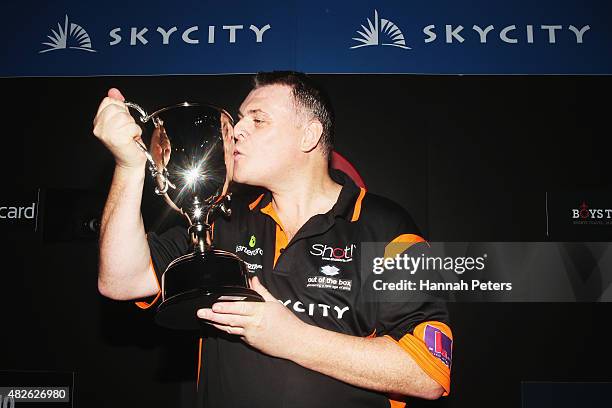 Craig Caldwell celebrates with the trophy after winning the Super League Darts Final between Warren Parry and Craig Caldwell at Sky City on August 1,...