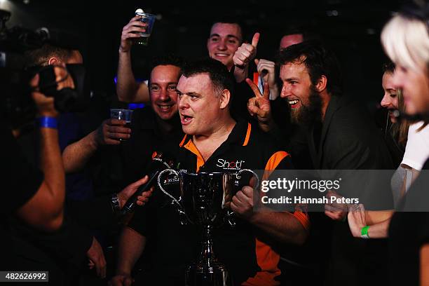 Craig Caldwell celebrates with the trophy after winning the Super League Darts Final between Warren Parry and Craig Caldwell at Sky City on August 1,...