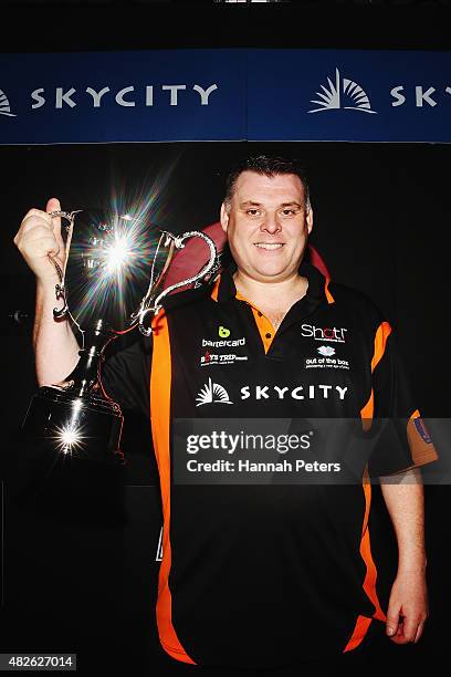 Craig Caldwell celebrates with the trophy after winning the Super League Darts Final between Warren Parry and Craig Caldwell at Sky City on August 1,...