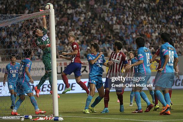 Goalkeeper Eisuke Fujishima of Sagan Tosu misses the save to let in a goal from a corner kick by Koke of Atletico Madrid during the friendly match...