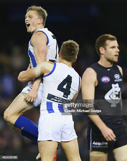 Jack Ziebell of the Kangaroos celebrates a goal with Shaun Higgins during the round 18 AFL match between the Carlton Blues and the North Melbourne...