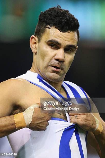 Lindsay Thomas of the Kangaroos celebrates a goal and points to his Aboriginal Flag tattoo during the round 18 AFL match between the Carlton Blues...