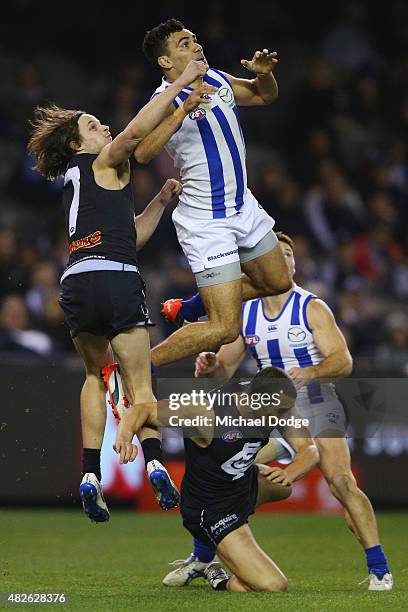 Lindsay Thomas of the Kangaroos competes for the ball over Ed Curnow of the Blues during the round 18 AFL match between the Carlton Blues and the...