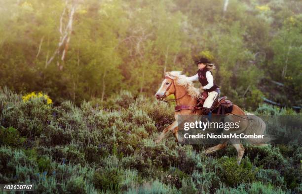 cowgirl speeding through sagebrush - montana western usa stock pictures, royalty-free photos & images