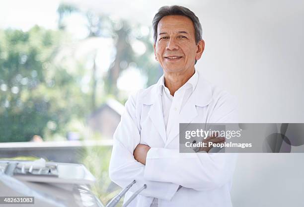 friendly face of your family dentist - dentist portrait stock pictures, royalty-free photos & images