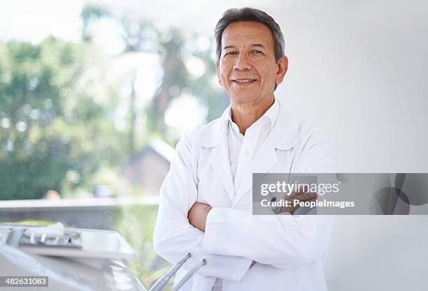 friendly face of your family dentist - white coat stock pictures, royalty-free photos & images