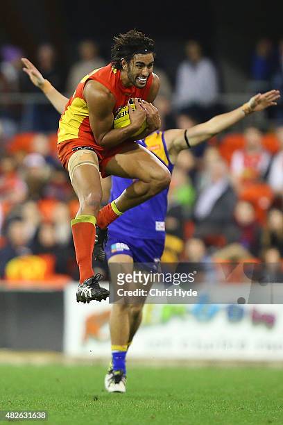 Tom Nicholls of the Suns takes a mark during the round 18 AFL match between the Gold Coast Suns and the West Coast Eagles at Metricon Stadium on...