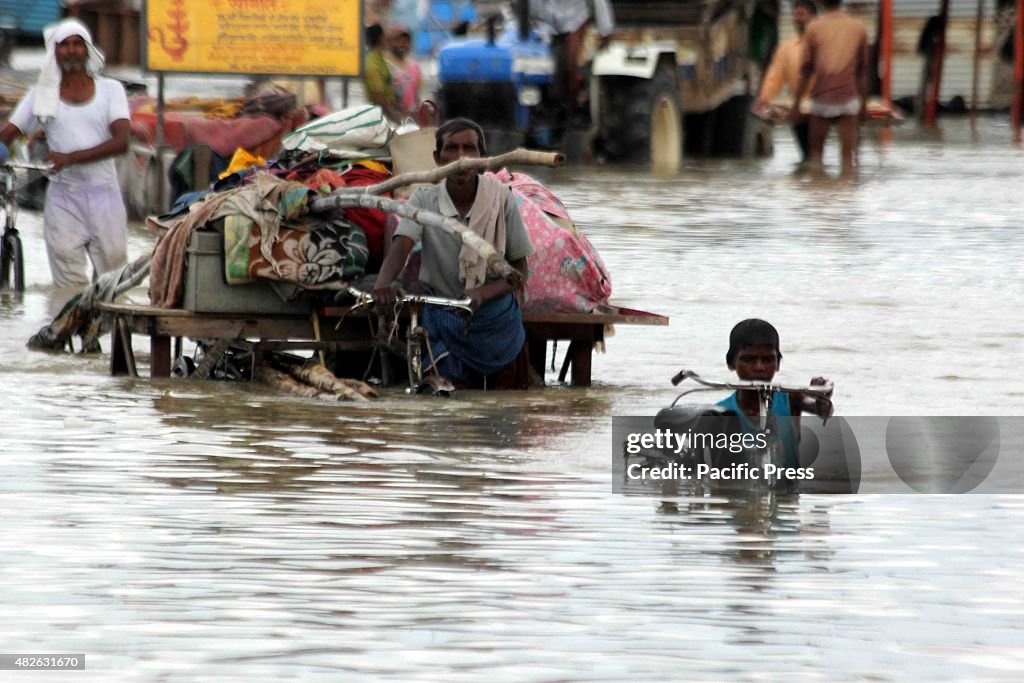 Devotees passing through the  flooded road after the water...