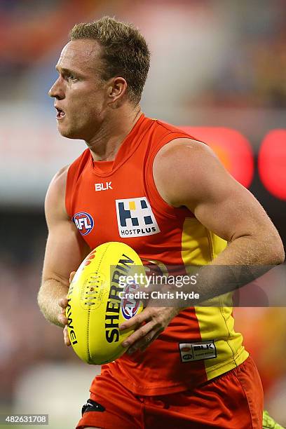 Brandon Matera of the Suns runs the ball during the round 18 AFL match between the Gold Coast Suns and the West Coast Eagles at Metricon Stadium on...