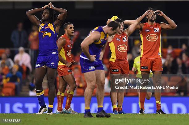 Players of the Suns and the Eagles look dejected during the round 18 AFL match between the Gold Coast Suns and the West Coast Eagles at Metricon...