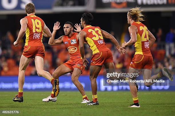 Harley Bennell of the Suns celebrates with goal scorer Tom Lynch during the round 18 AFL match between the Gold Coast Suns and the West Coast Eagles...