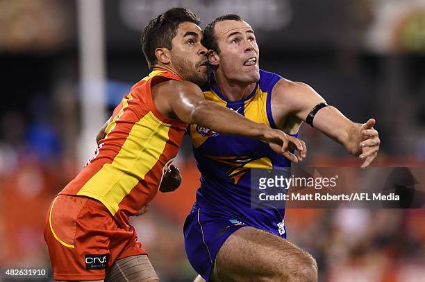 Jack Martin of the Suns competes for the ball with Shannon Hurn of the Eagles during the round 18 AFL match between the Gold Coast Suns and the West...
