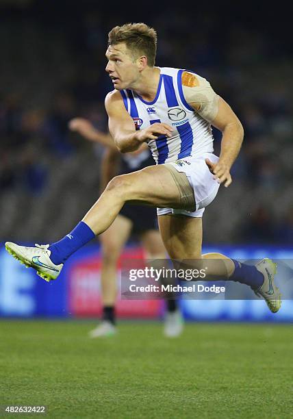 Shaun Higgins of the Kangaroos kicks the ball during the round 18 AFL match between the Carlton Blues and the North Melbourne Kangaroos at Etihad...