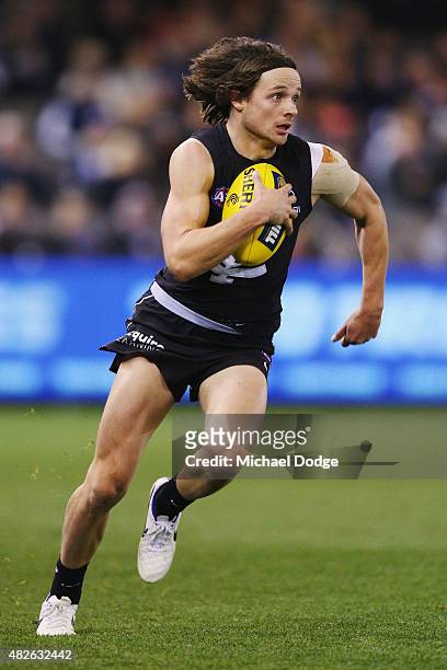 Dylan Buckley of the Blues runs with the ball during the round 18 AFL match between the Carlton Blues and the North Melbourne Kangaroos at Etihad...