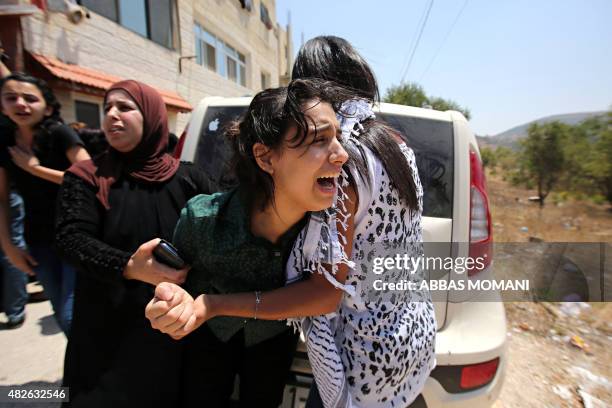 Talia, the sister of 14-year-old Palestinian Laith Khaldi, mourns during the funeral of her brother who died of his wounds after he was shot during...