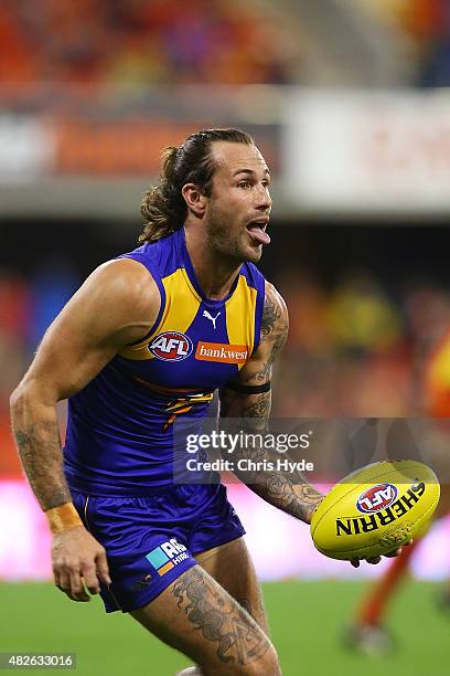 Chris Masten of the Eagles runs the ball during the round 18 AFL match between the Gold Coast Suns and the West Coast Eagles at Metricon Stadium on...