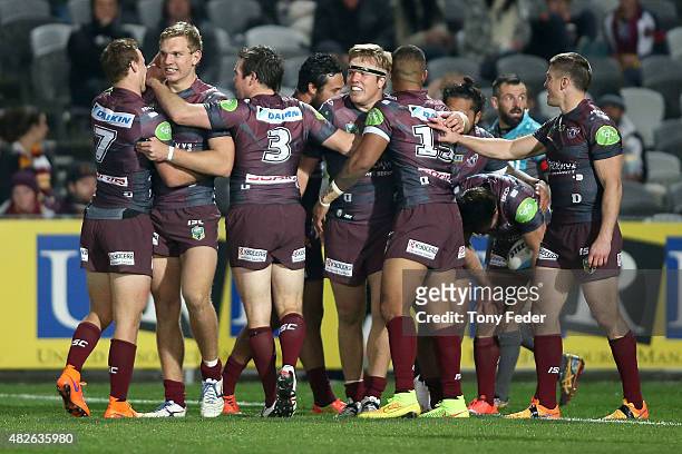 Sea Eagles players celebrate a try during the round 21 NRL match between the Manly Sea Eagles and the Brisbane Broncos at Central Coast Stadium on...